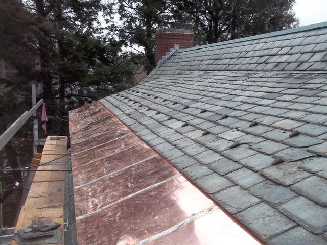 copper roofing contractors working on a home in Massachusetts