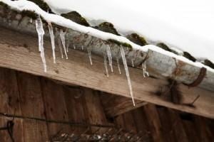 Different types of Ice Dam Damage|"Different Types of damaged caused by of Ice Dams" on top of a roof with an ice dam and snow.